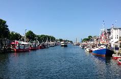 Picture: Rostock-Warnemünde "Alter trom" (old harbour approach channel) with fisher and tourist boats.